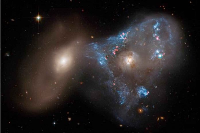 Galaxy collision creates 'space triangle' in new Hubble image